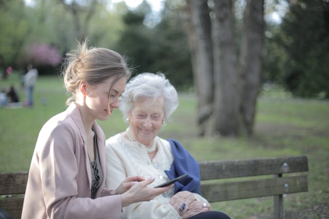 elder law attorney, image of senior woman and middle-aged woman on park bench