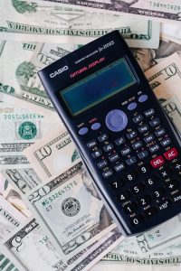 fund a trust, image of a calculator on top of paper money