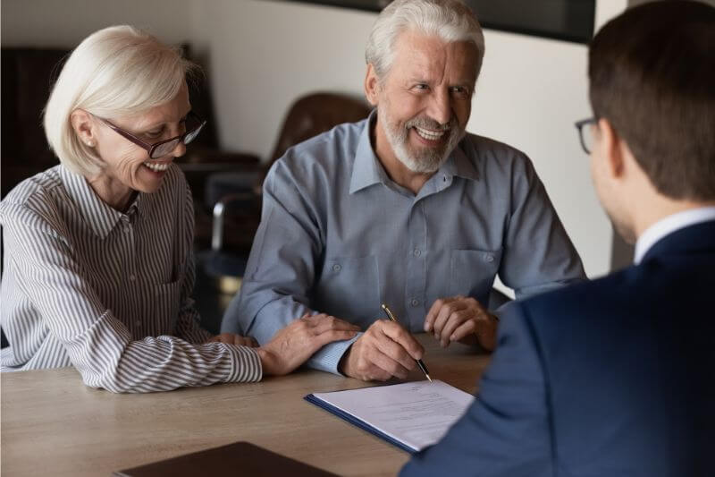 Warren, New Jersey Business Owners and Asset Protection; an older couple sign important paperwork