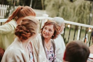 New Jersey Medicaid asset limit, image of a middle-aged woman chatting with others outdoors