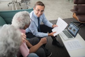 estate planning documents, image of an in suit explaining a document to a senior couple